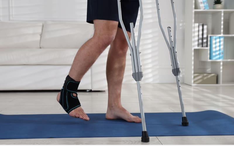 Patient performing guided rehabilitation exercises with a physiotherapist to improve limited mobility after surgery in a recovery clinic.